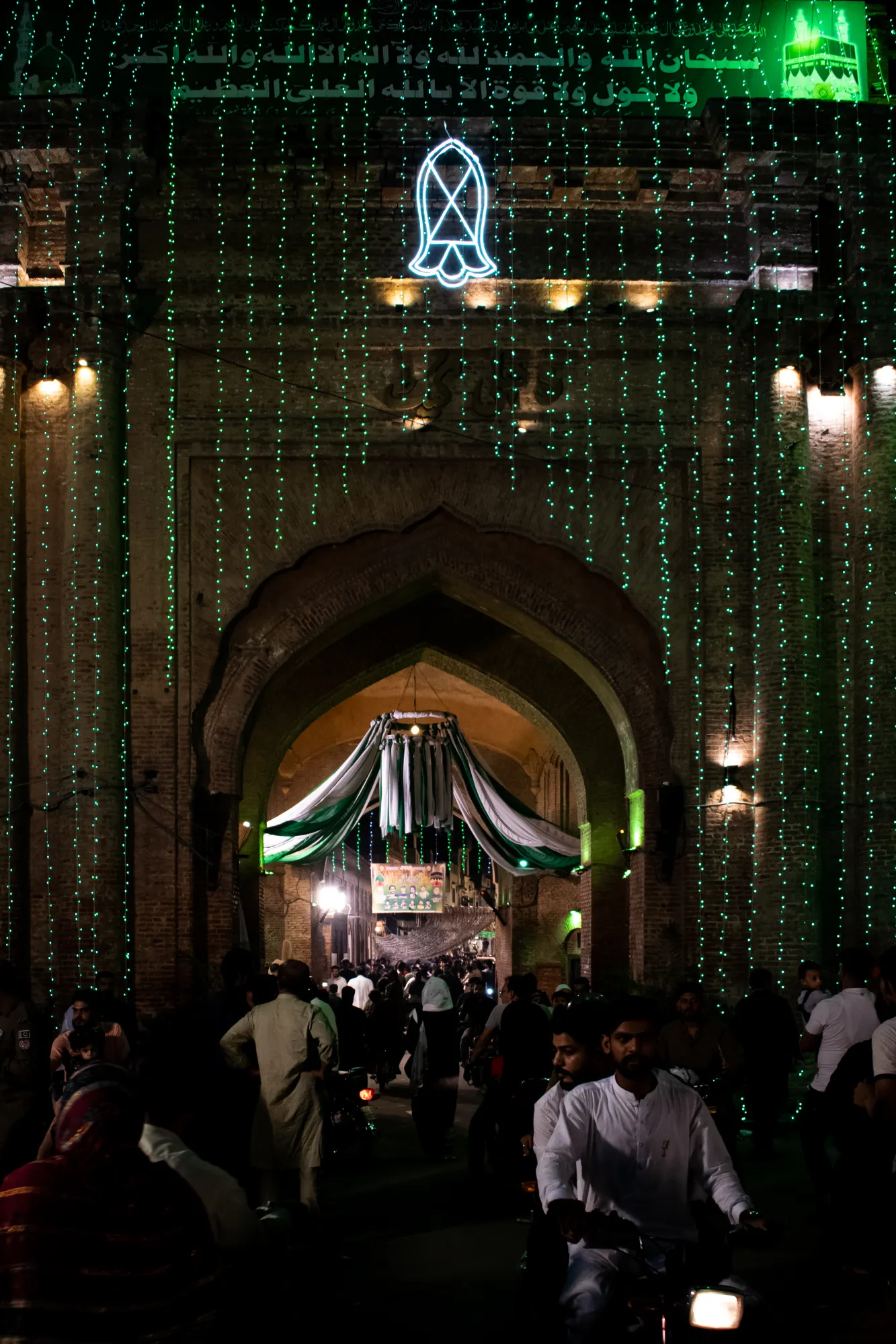 Delhi Gate lined with green fairy lights with nalayeen pak mounted on the top