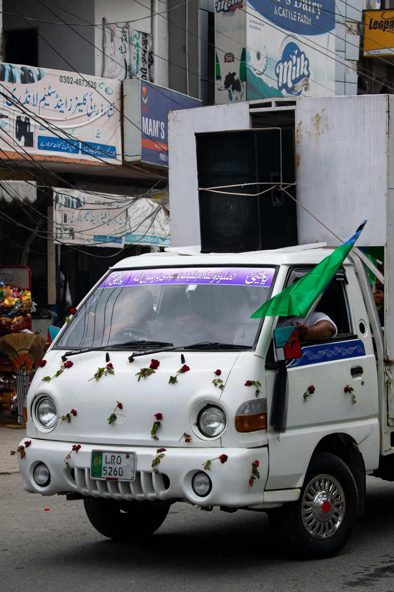 A loud speaker tied on top of a van’s roof leading the jaloos, energising the procession with naat